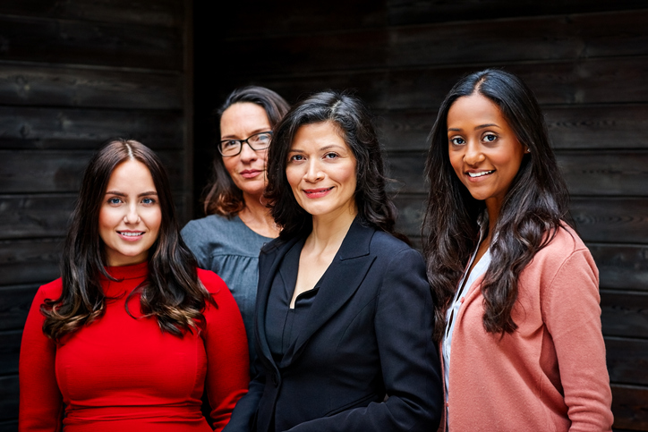 Group of diverse business women standing together in office